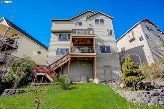 rear view of property featuring central AC, a yard, and stairs