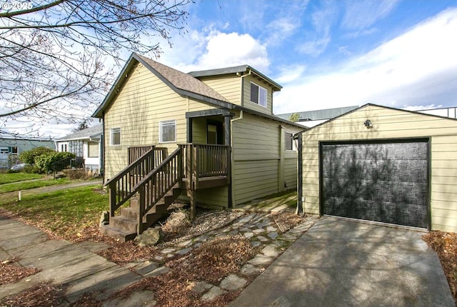 view of front facade with driveway, an outdoor structure, and a garage