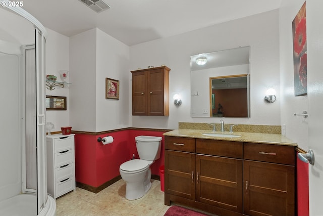 full bathroom with a shower stall, vanity, and toilet