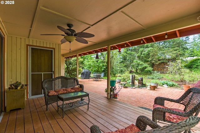 wooden terrace with ceiling fan and a patio