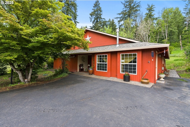 view of front of home featuring a shingled roof