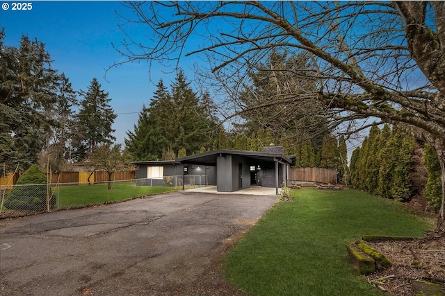 view of front of home with a front yard and a carport