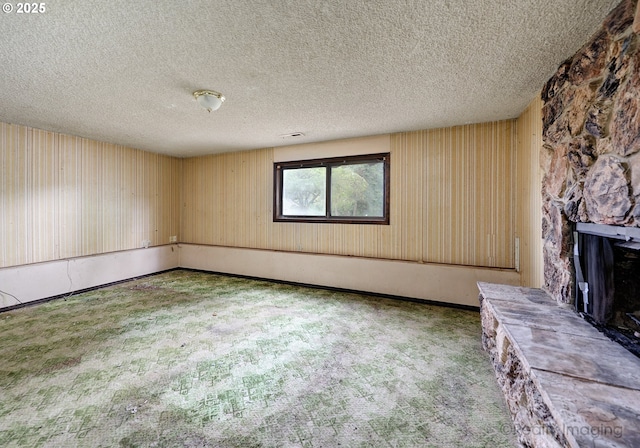 14251 Caufield Rd, Oregon City, OR 97045 - unfurnished living room with carpet floors, a textured ceiling, and a fireplace