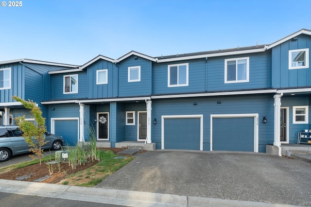 8512 NE 13th Pl, Vancouver, WA 98665 - townhome / multi-family property with board and batten siding, an attached garage, and asphalt driveway