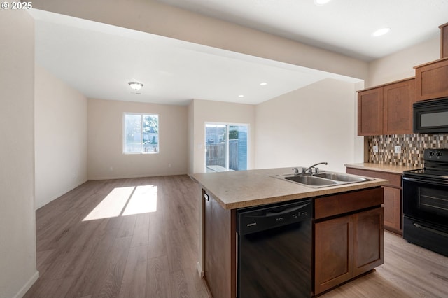8512 NE 13th Pl, Vancouver, WA 98665 - kitchen with black appliances, light wood-style floors, open floor plan, decorative backsplash, and an island with sink