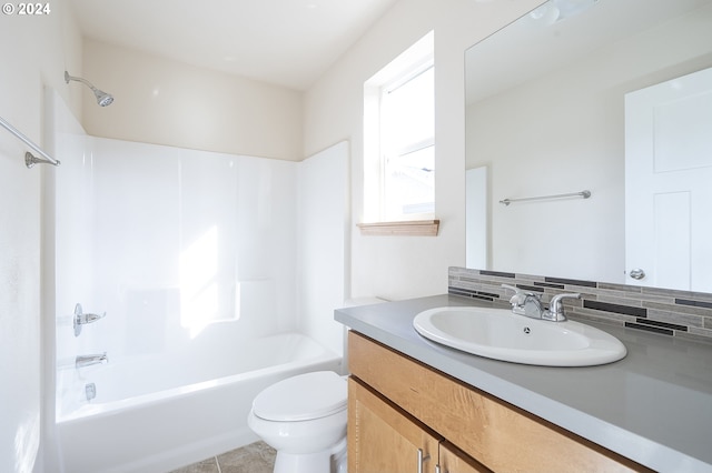 full bathroom with toilet, tub / shower combination, vanity, tile patterned flooring, and decorative backsplash