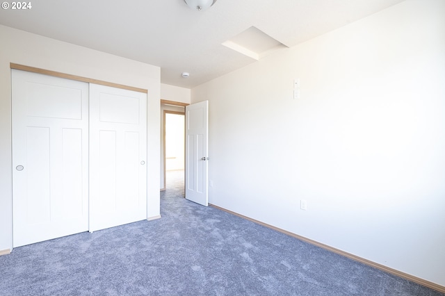 unfurnished bedroom featuring a closet and carpet flooring