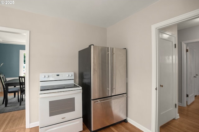 7414 N Chautauqua Blvd, Portland, OR 97217 - kitchen featuring electric range, freestanding refrigerator, and light wood-style floors