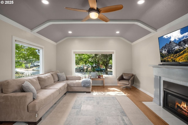 7414 N Chautauqua Blvd, Portland, OR 97217 - living area featuring vaulted ceiling, a fireplace with flush hearth, healthy amount of natural light, light wood-type flooring, and a ceiling fan