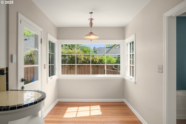 7414 N Chautauqua Blvd, Portland, OR 97217 - unfurnished dining area with light wood-style floors and baseboards