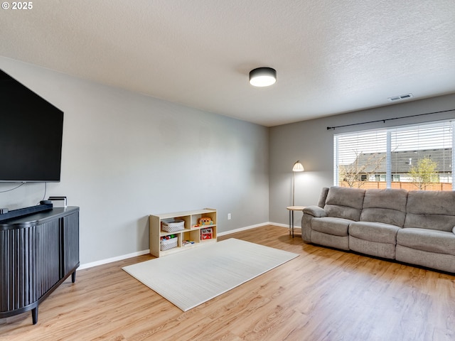 11411 NE 131st Pl, Vancouver, WA 98682 - living room with visible vents, baseboards, light wood finished floors, and a textured ceiling
