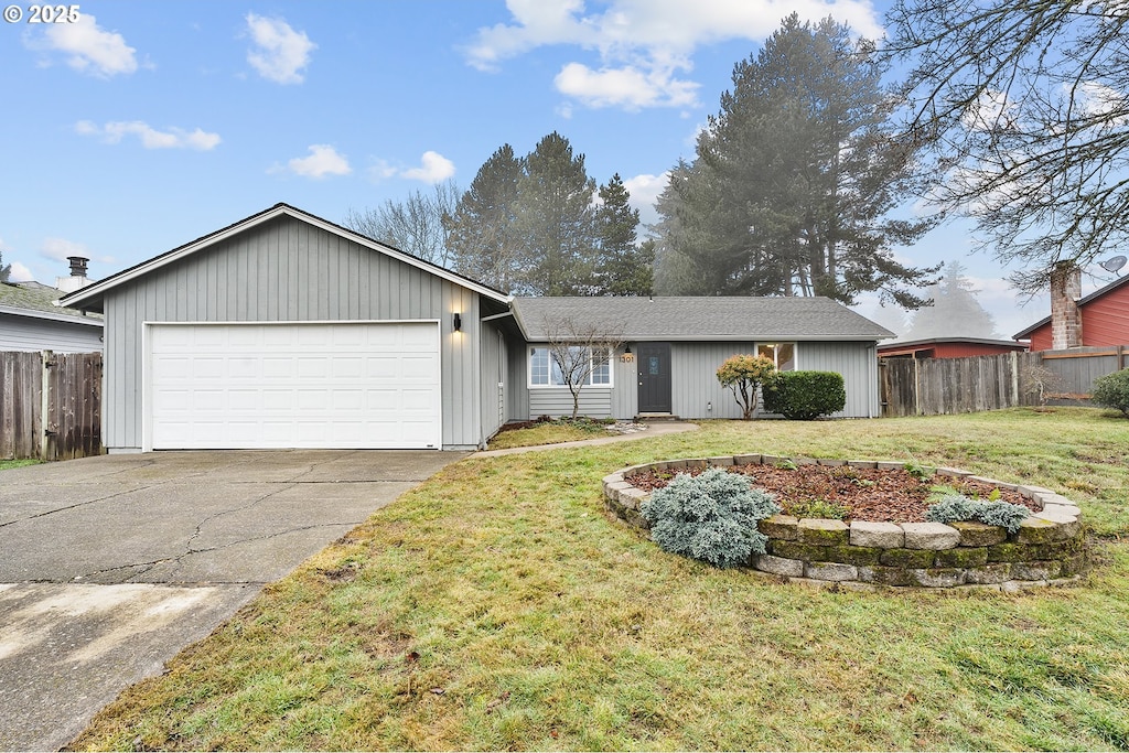 ranch-style house featuring a garage and a front yard