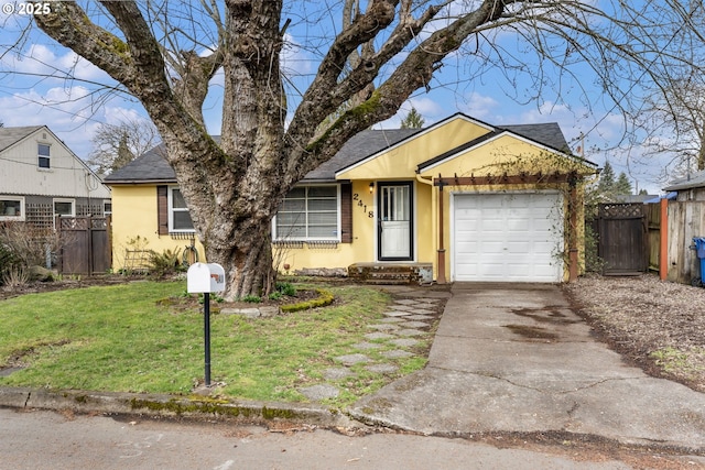 ranch-style house featuring a front yard, fence, stucco siding, concrete driveway, and a garage