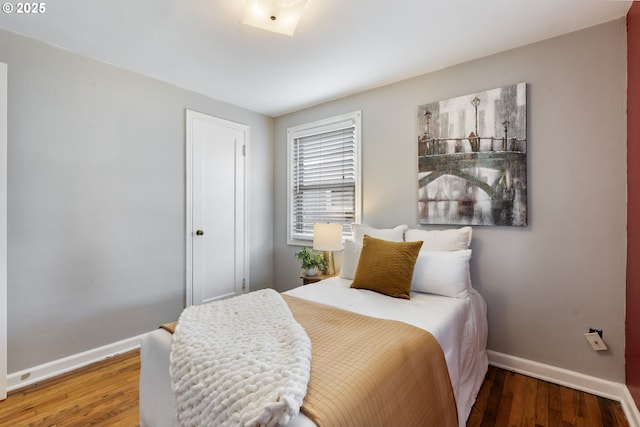 bedroom featuring wood finished floors and baseboards