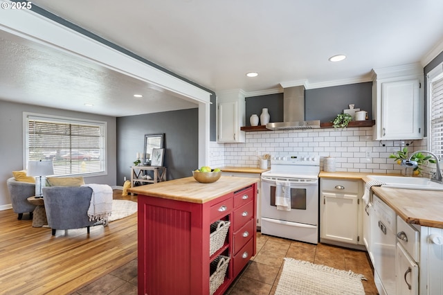 kitchen with wooden counters, white appliances, wall chimney exhaust hood, and open shelves