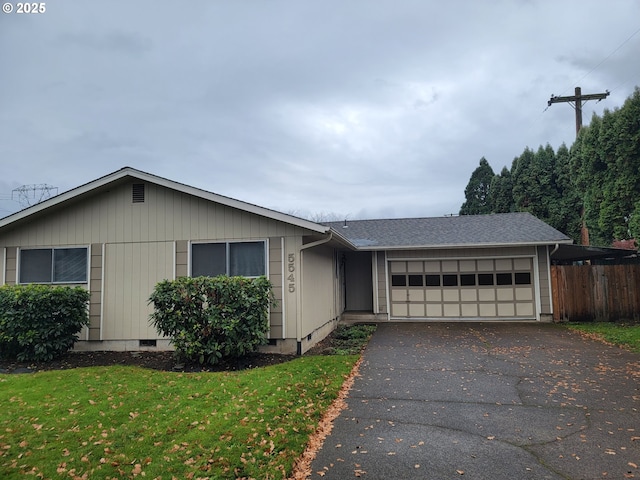 view of front of home with a front yard and a garage