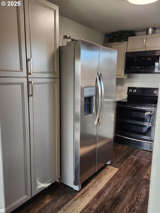 kitchen featuring dark hardwood / wood-style flooring and stainless steel appliances