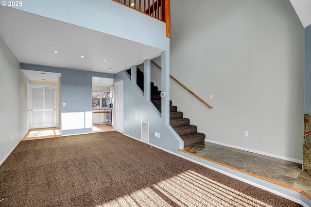 interior space with visible vents, baseboards, carpet, stairway, and recessed lighting