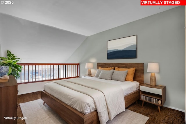 bedroom with carpet floors, baseboards, and vaulted ceiling