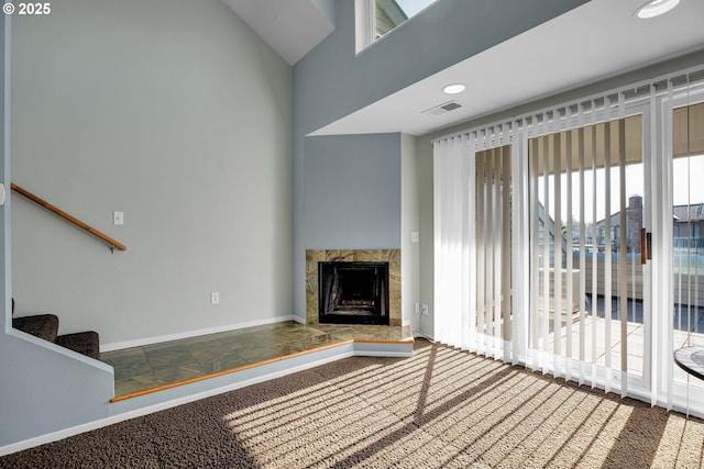 unfurnished living room with visible vents, baseboards, stairs, recessed lighting, and a fireplace