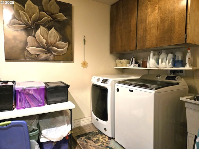 washroom with cabinets and washing machine and dryer