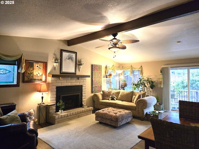 living room featuring ceiling fan, a fireplace, lofted ceiling with beams, and a textured ceiling