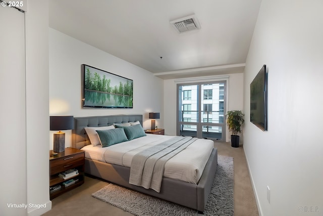 bedroom featuring light colored carpet