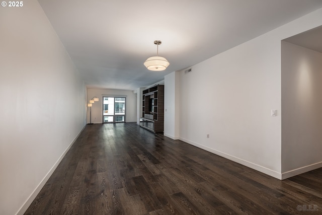 unfurnished living room with dark hardwood / wood-style floors