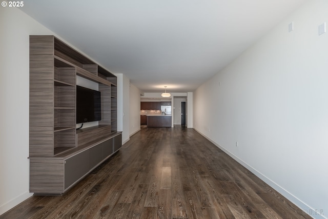 corridor with dark hardwood / wood-style flooring