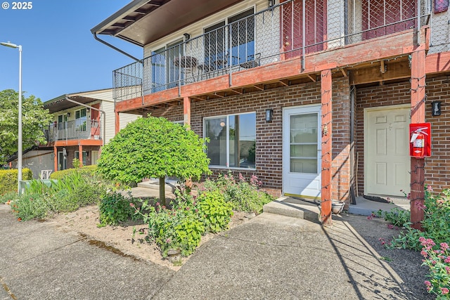 entrance to property featuring brick siding