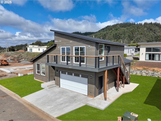 30403 Sawyer Way, Gold Beach, OR 97444 - view of front of home featuring a garage, a front yard, driveway, a mountain view, and stairway