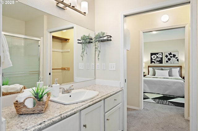 full bathroom with vanity, baseboards, a shower with shower door, and ensuite bath