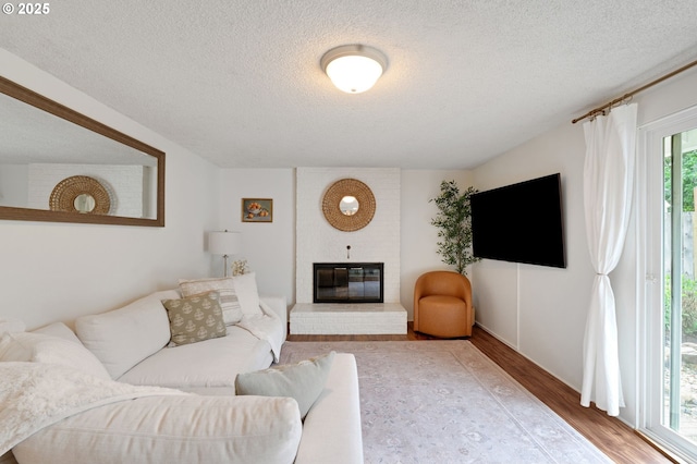 3138 Kentwood Dr, Eugene, OR 97401 - living room with a textured ceiling, wood finished floors, and a fireplace