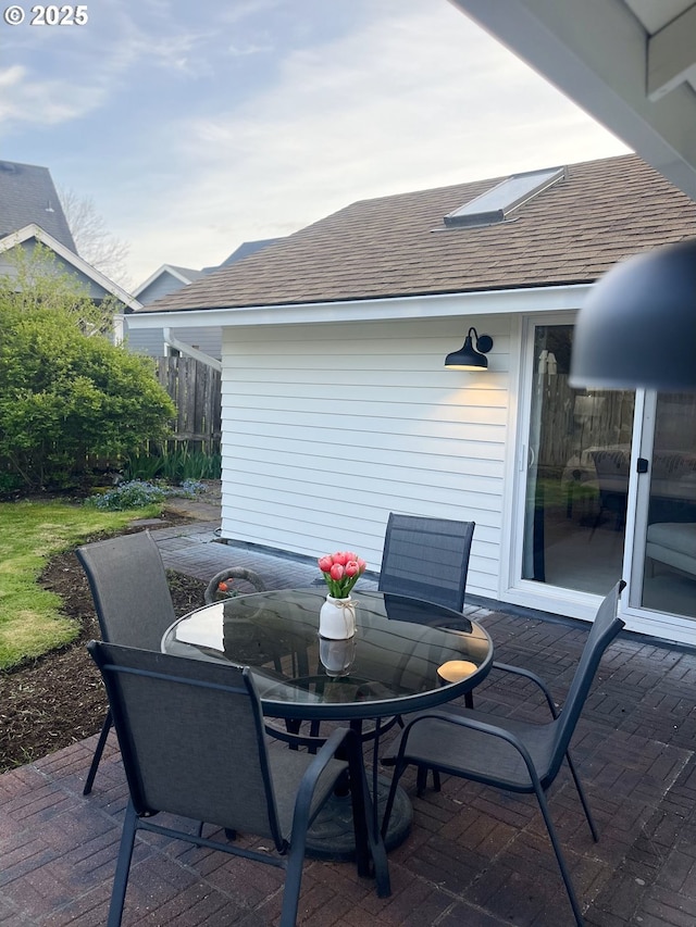 view of patio with fence and outdoor dining area