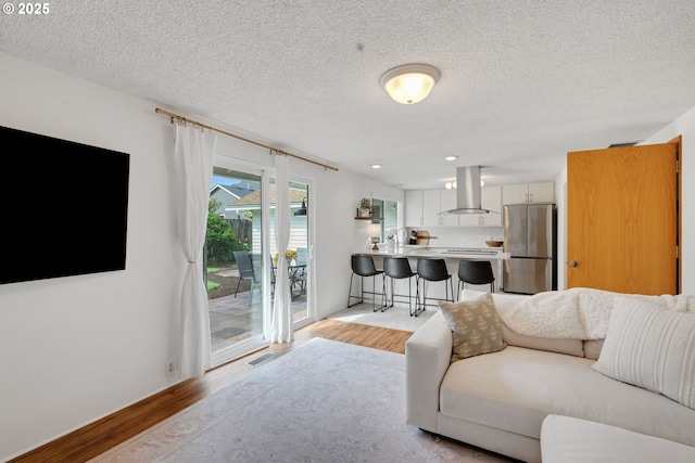 3138 Kentwood Dr, Eugene, OR 97401 - living room featuring light wood-style floors, a textured ceiling, and recessed lighting