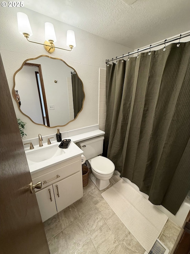 bathroom with a shower with shower curtain, vanity, a textured ceiling, and toilet