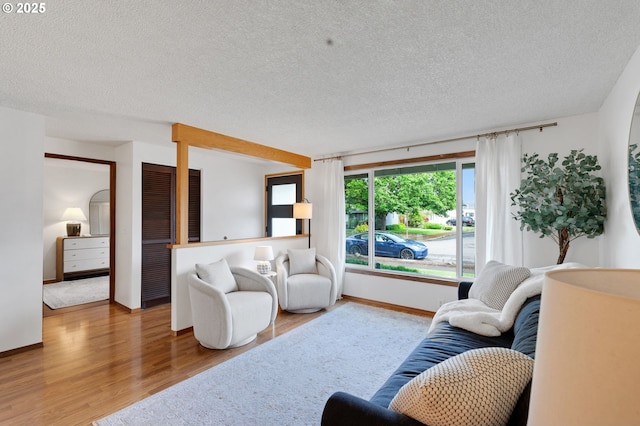 3138 Kentwood Dr, Eugene, OR 97401 - living room featuring wood finished floors, a textured ceiling, and baseboards