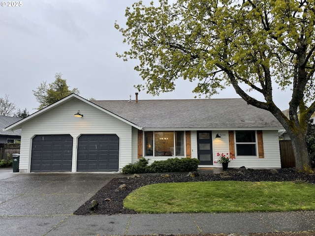 ranch-style house featuring concrete driveway, a front lawn, a garage, fence, and a shingled roof