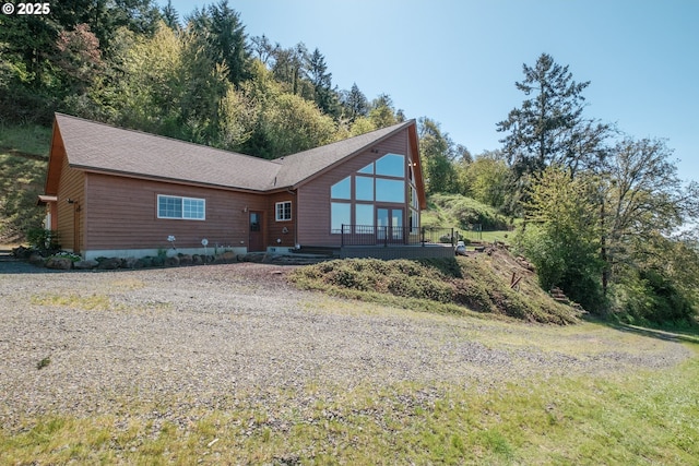 back of property with a shingled roof