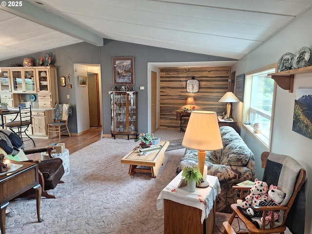 carpeted living room with vaulted ceiling with beams and wood finished floors