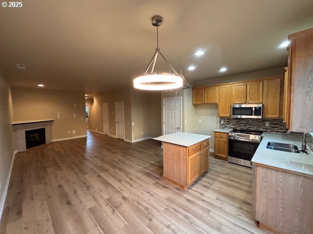 room details featuring a tile fireplace and wood-type flooring