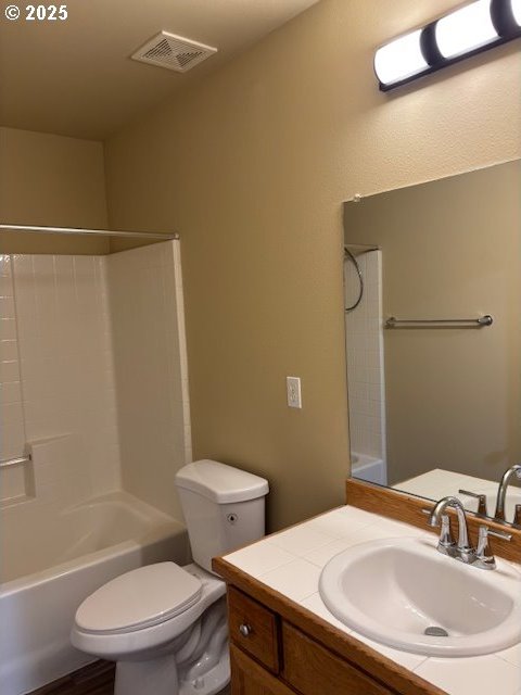 full bathroom with vanity, toilet, and  shower combination