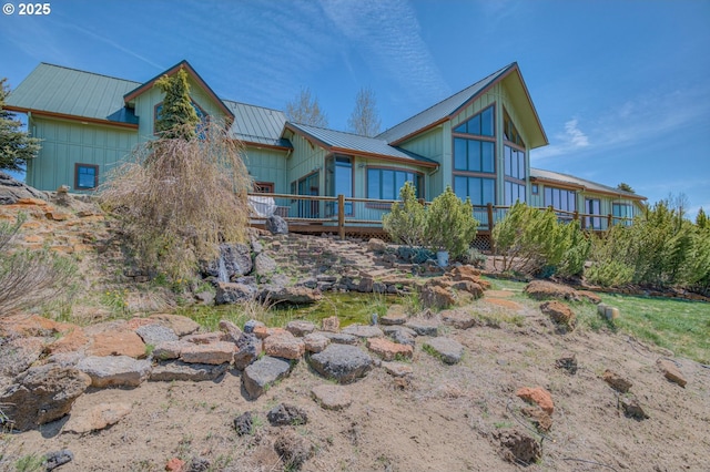 52995 Riverview Dr, La Pine, OR 97739 - back of property featuring a wooden deck, metal roof, and board and batten siding