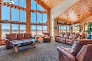 living room featuring high vaulted ceiling, carpet, wood ceiling, and a healthy amount of sunlight