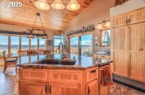 kitchen featuring lofted ceiling, a sink, wood ceiling, a center island, and decorative light fixtures