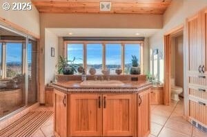 52995 Riverview Dr, La Pine, OR 97739 - bar area with light tile patterned flooring, a sink, and wooden ceiling