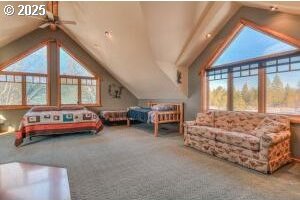 carpeted bedroom featuring lofted ceiling