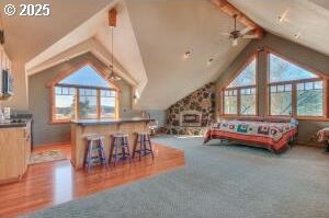 additional living space with vaulted ceiling with beams, ceiling fan, and a wealth of natural light