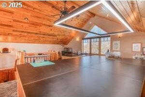 additional living space with lofted ceiling with beams and concrete floors