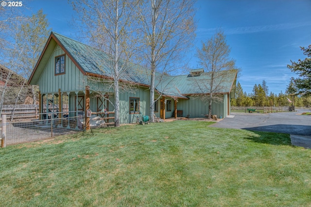 52995 Riverview Dr, La Pine, OR 97739 - view of front facade featuring board and batten siding, asphalt driveway, and metal roof